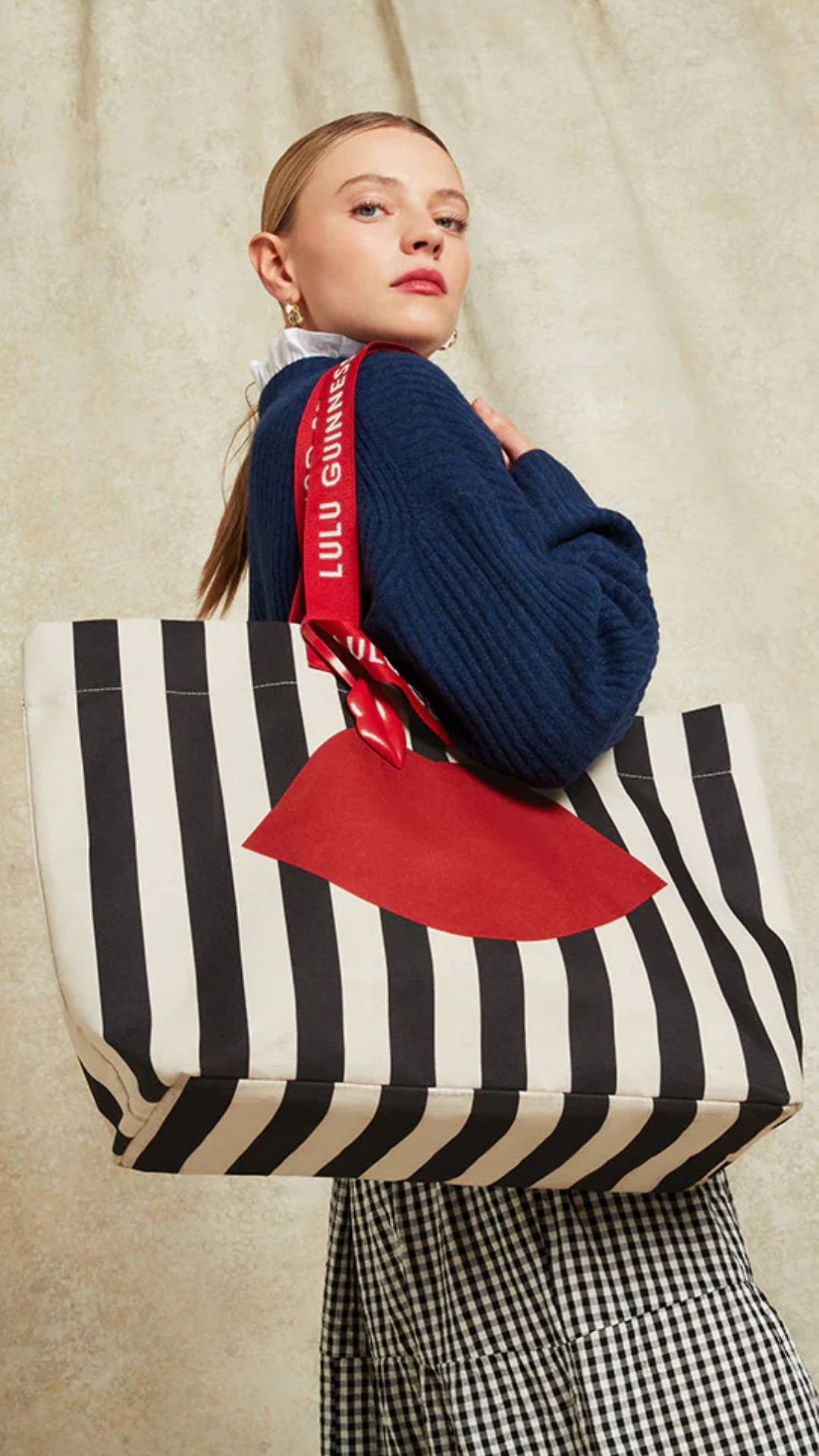 a model holding the lulu guinness tote bag