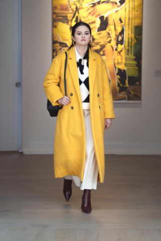 Selena Gomez in a big yellow coat in Season 2 of Only Murders in the Building.
