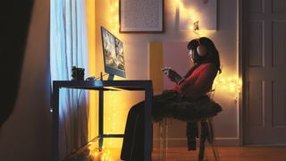 A woman gaming on the new iMac M3
