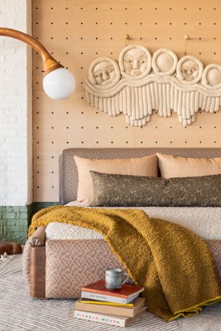 a bedroom with a textured wall hanging