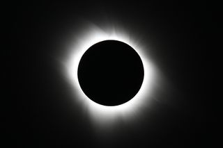 This view of the sun’s extremely hot outer atmosphere, called the corona, was captured by Edwin Aguirre and Imelda Joson from the South Pacific during the total solar eclipse on July 11, 2010. Note the moon’s pitch-black silhouette and the corona’s fine structural details.