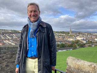 Michael on the City Walls with a view of Derry in the background.