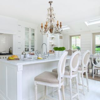 kitchen with chandelier and white interiors