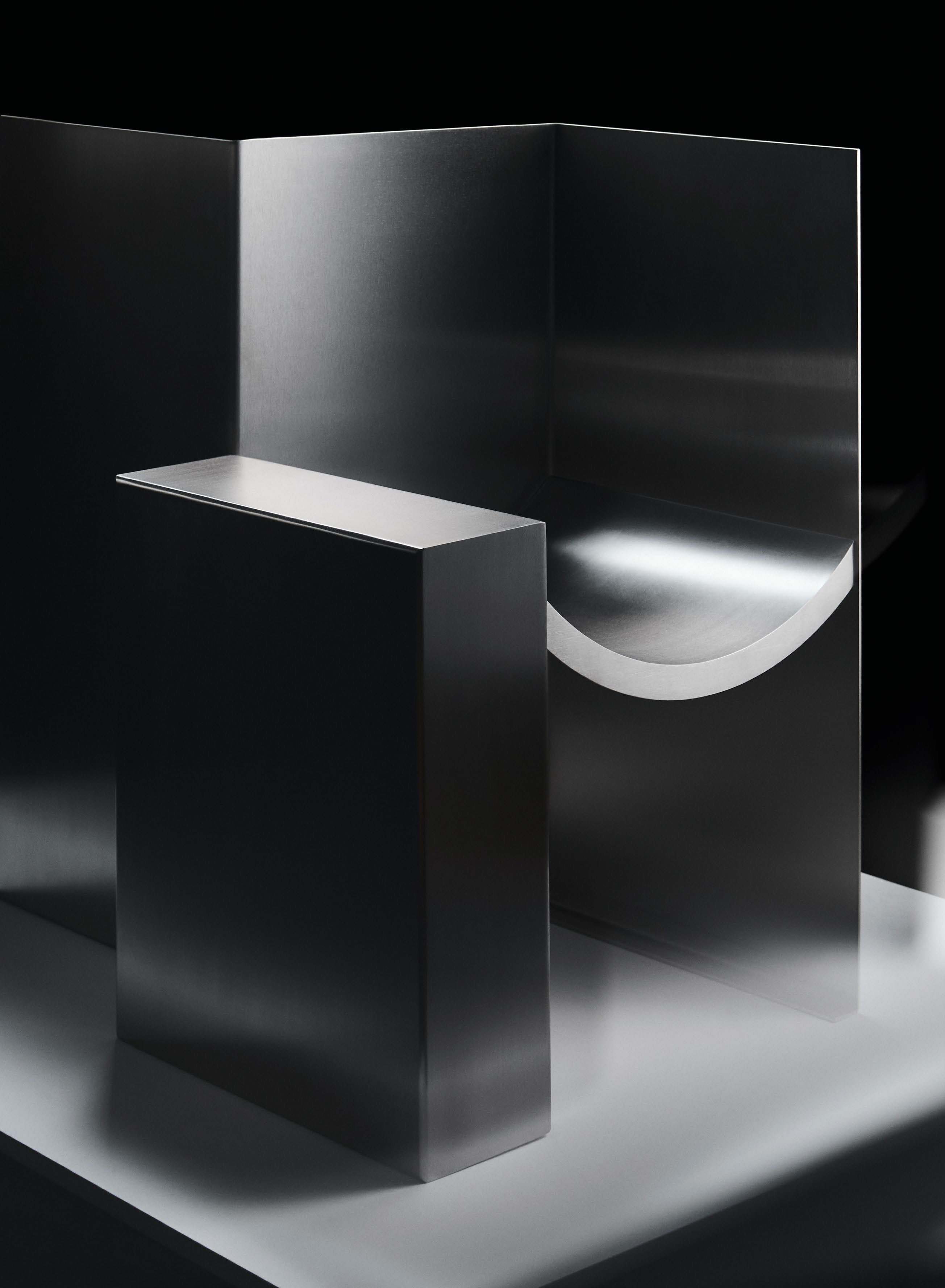 A minimalist stainless steel sculpture featuring geometric forms, highlighting the interplay of space and materiality, reflecting the work of designer Pauline Leprince.