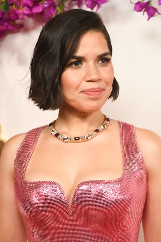 America Ferrera wearing a pink sequin dress with her hair cut into a short wavy bob.