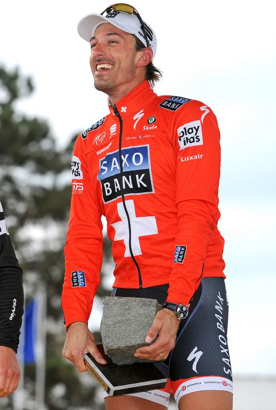 Fabian Cancellara in the Swiss national jersey about to lift the cobble