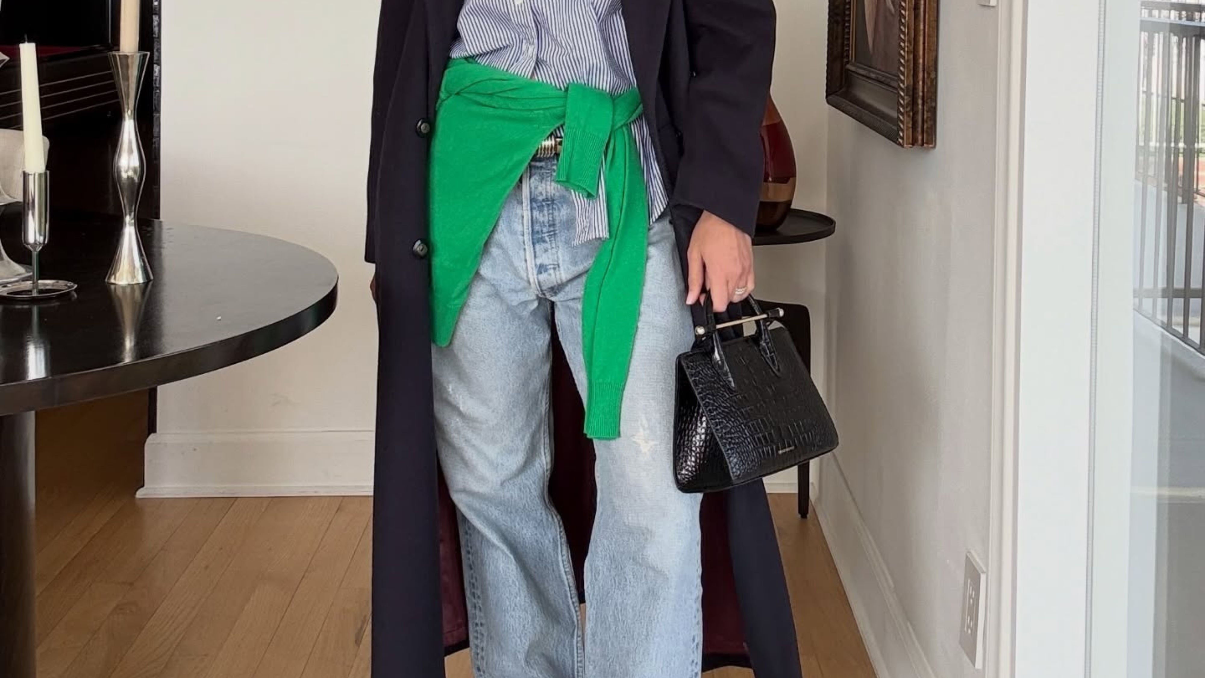 Jen Wonders wearing light-washed jeans with cinched loafers.