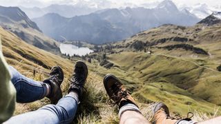 Germany, Bavaria, Oberstdorf, legs of two hikers resting in alpine scenery