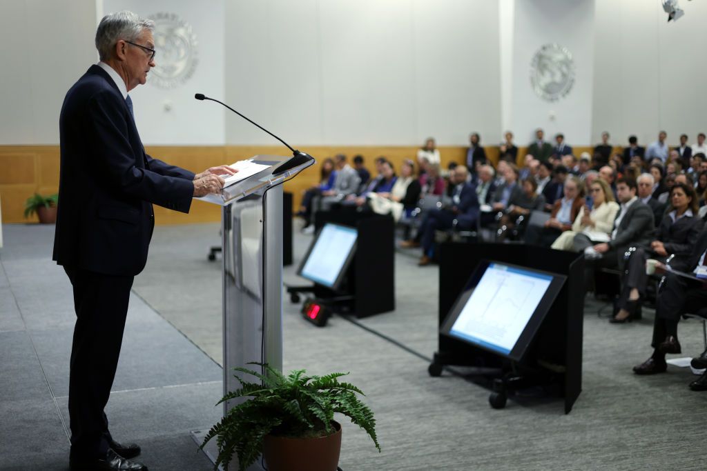 US Federal Reserve Chair Jerome Powell standing at podium in front of group giving a speech