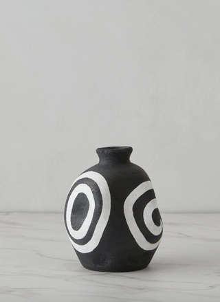 black and white stoneware vase with circular patterns painted on