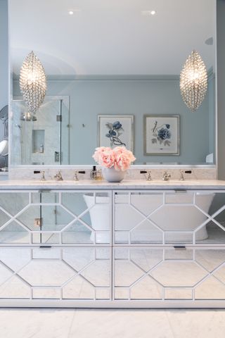 An example of how to make a small bathroom look bigger showing a bathroom with mirrored furniture