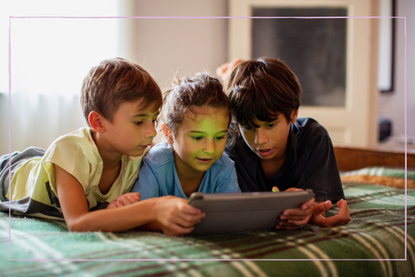 three kids using a tablet together