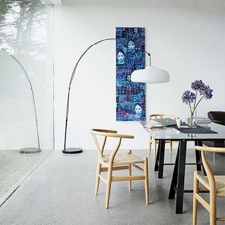 room with white wall and table and chairs with side lamp