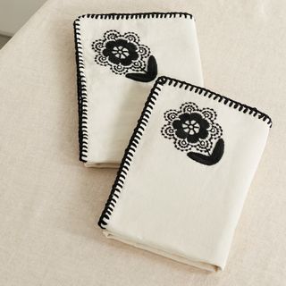 White napkin with black flower embroidery