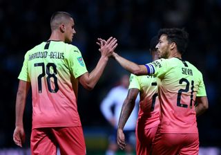 PRESTON, ENGLAND - SEPTEMBER 24: Taylor Harwood-Bellis of Manchester City (L) celebrates with David Silva of Manchester City after their team's third goal, an own goal by Ryan Ledson of Preston North End during the Carabao Cup Third Round match between Preston North Endand Manchester City at Deepdale on September 24, 2019 in Preston, England. (Photo by Alex Livesey/Getty Images)