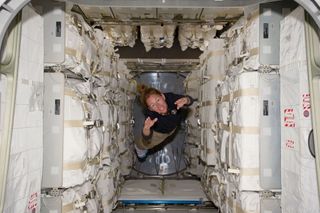 NASA astronaut Sandy Magnus flies through the Rafaello module, filled to the brim with supplies, during the final space shuttle mission (STS-135) to the International Space Station.