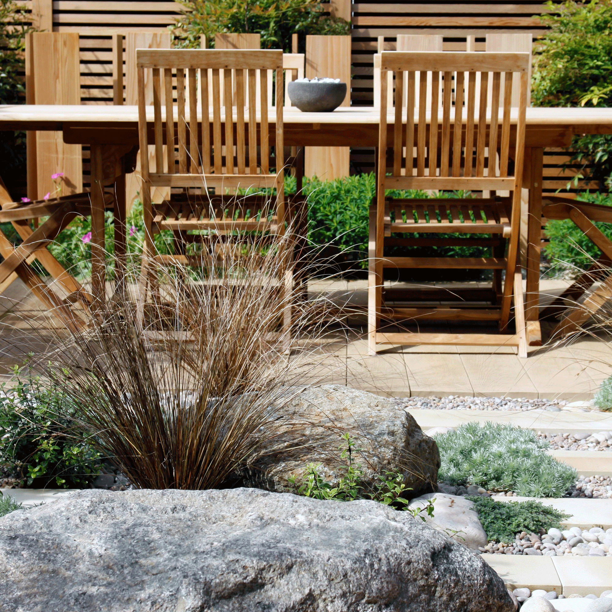 Rock garden with wooden furniture