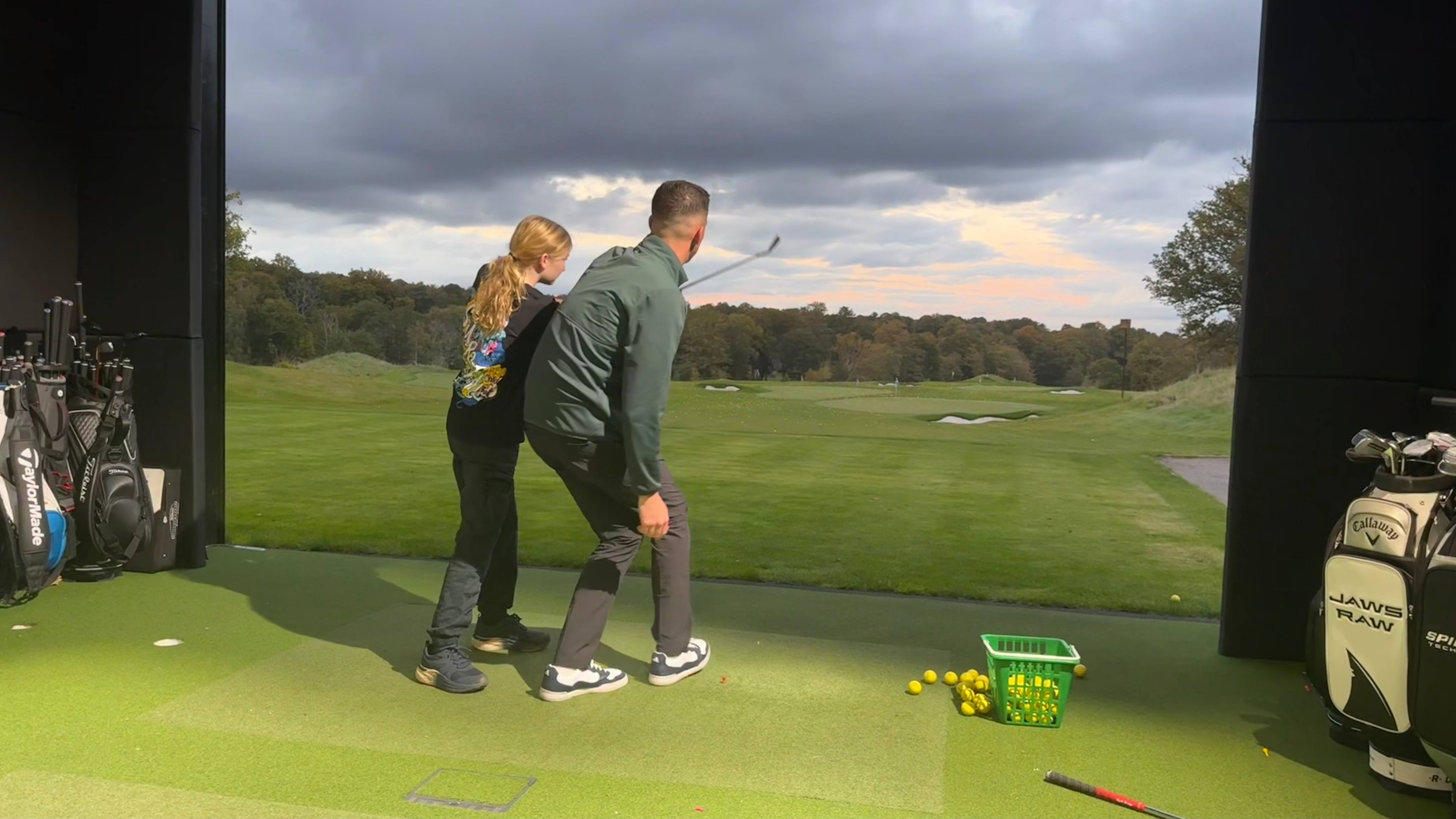 Libby Dawkins having a golf lesson