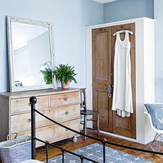 room with white wall and dressing table and wardrobe and wooden floor