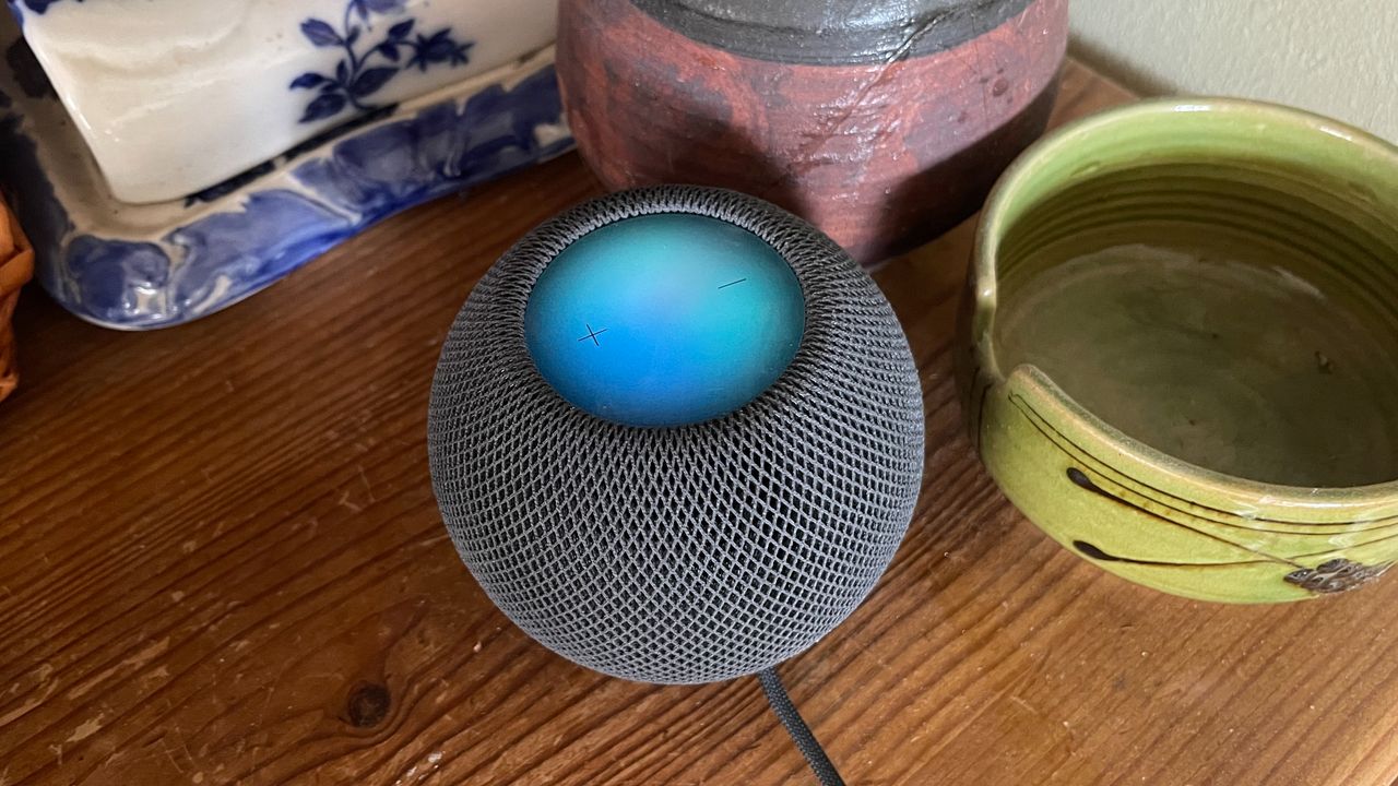 HomePod Mini on a wooden countertop