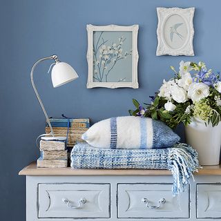 blue bedroom with white chest of drawers
