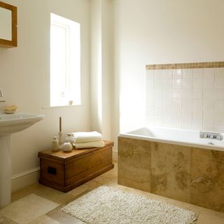 bathroom with white wall window bathtub and wash basin