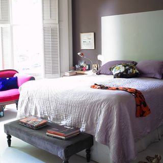 master bedroom with white bedlinen and books