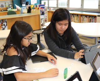 Fifth-grade students at Highland Elementary School collaborate on a literacy project.