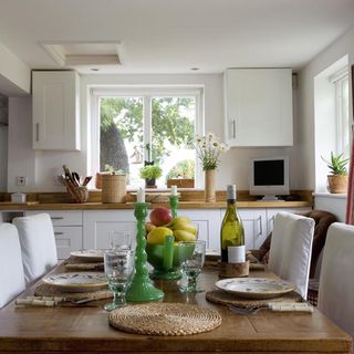 kitchen dining area with dining table and white chair