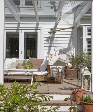 raised patio under veranda with hanging chair