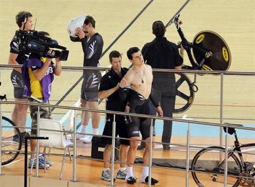 Sam Michael Webster (New Zealand) is helped away following his crash in the men's team sprint.