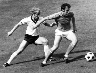 Yugoslavia's Dragan Dzajic (right) holds off West Germany's Berti Vogts at the 1974 World Cup.