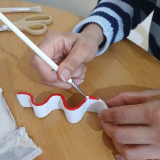 An incense holder made from air dry clay being painted