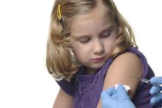 A young girl receives a vaccination.