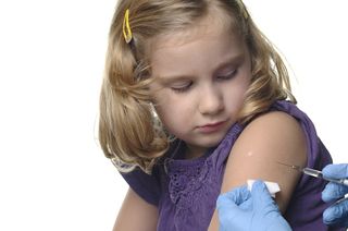 A young girl receives a vaccination.