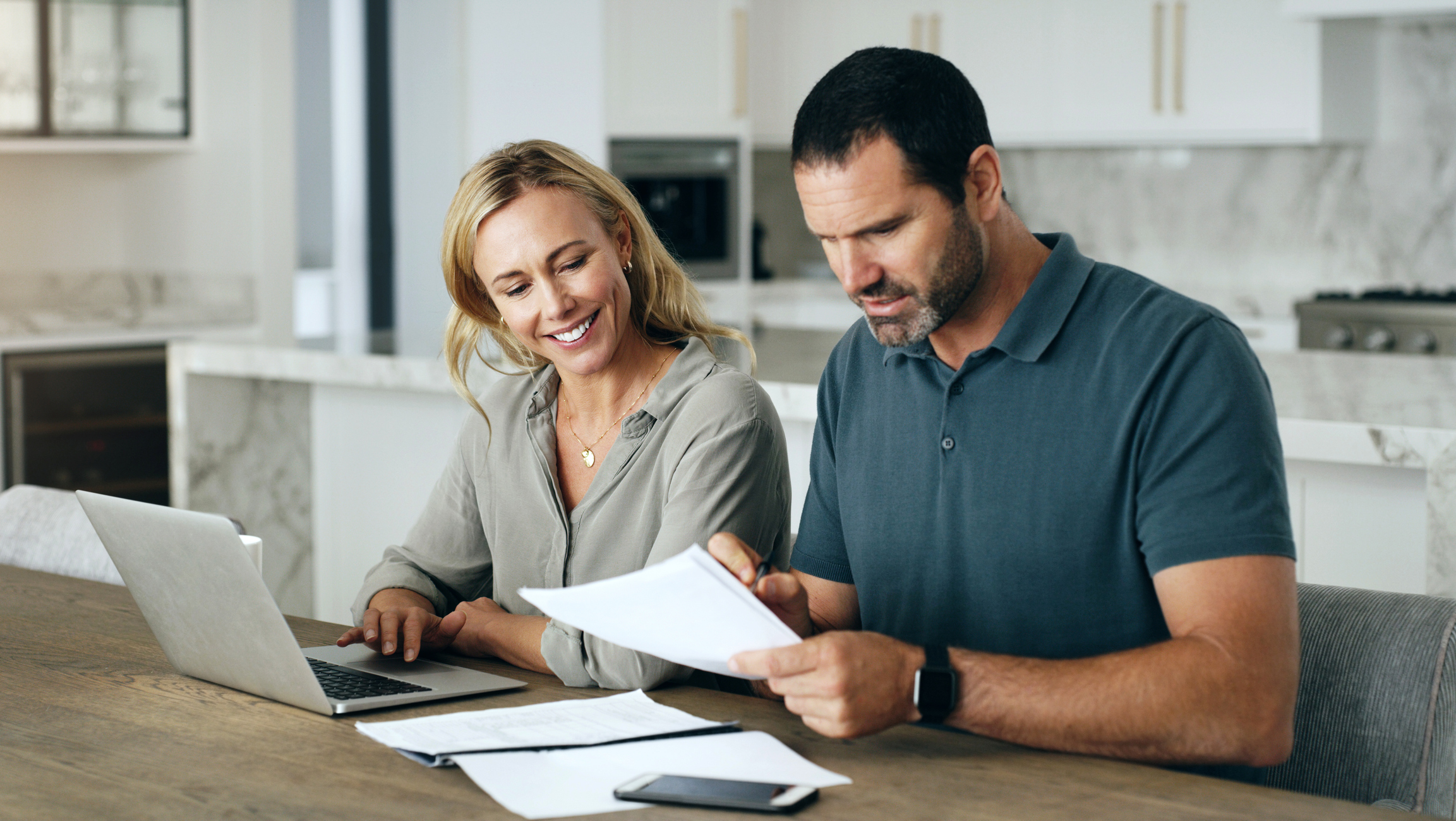 Finance, budget or couple writing or planning for financial investments on laptop with a happy smile at home. Documents, insurance or mature people working savings, mortgage paperwork or loan taxes