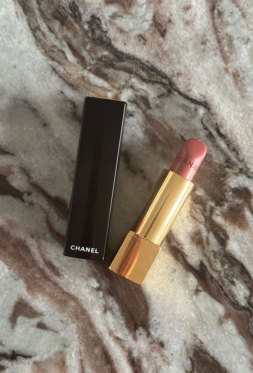 Chanel Rouge Allure lipstick on a marble texture background