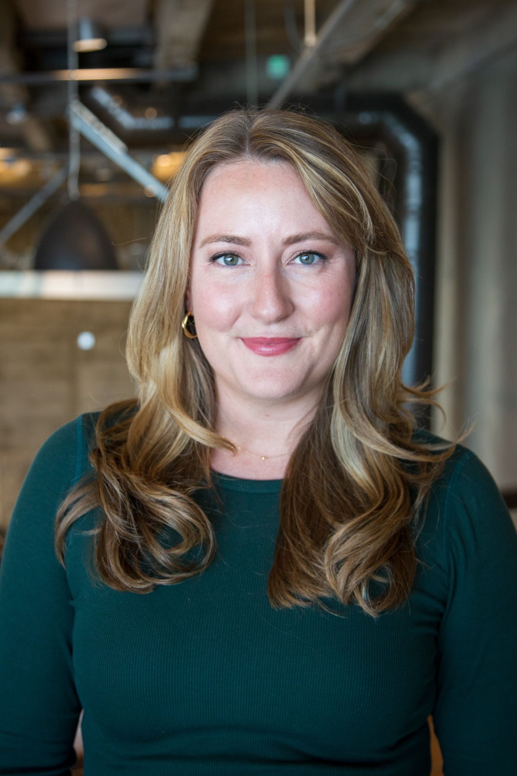 Headshot of Emily Glanton in a green shirt