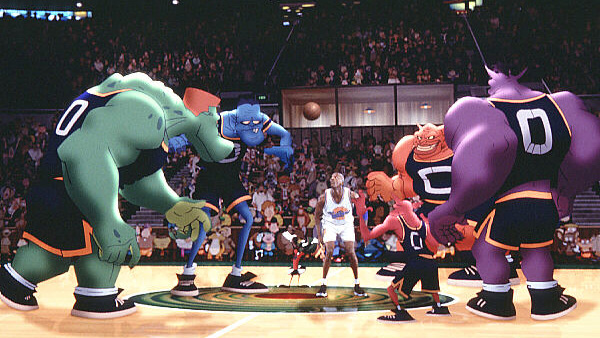 A still from the movie Space Jam showing all the main characters on a basketball court