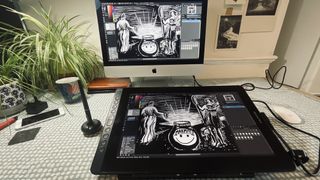 A photo of the Huion Kamvas 16 (2021) drawing tablet connected to a monitor and computer