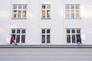 women talking to each other across windows - second coronavirus wave lockdown