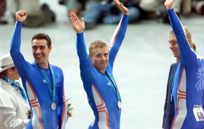 The British team, composed by Jason Queally, Craig Mac Lean and Chris Hoy (From L to R), celebrates on the podium 17 September 2000 after winning the silver medal in the men's olympic sprint competition of the Sydney 2000 Olympic Games