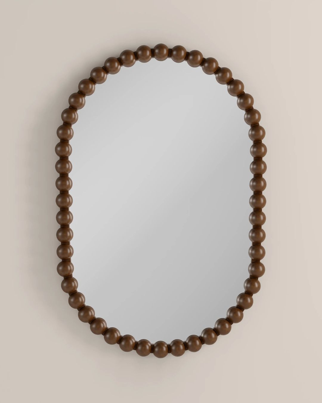 Ashby Oval Wall Mirror, 90 X 60 Cm in Walnut against beige background.