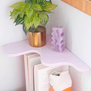 Lavender wavy corner shelf with potted plant