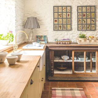 kitchen with antique cabinet unit and terracotta tiles british standard