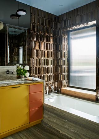 a bathroom with brown wall tiles