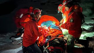 A group of Forest Rangers assisting a victim of falling ice at Kaaterskill Falls.