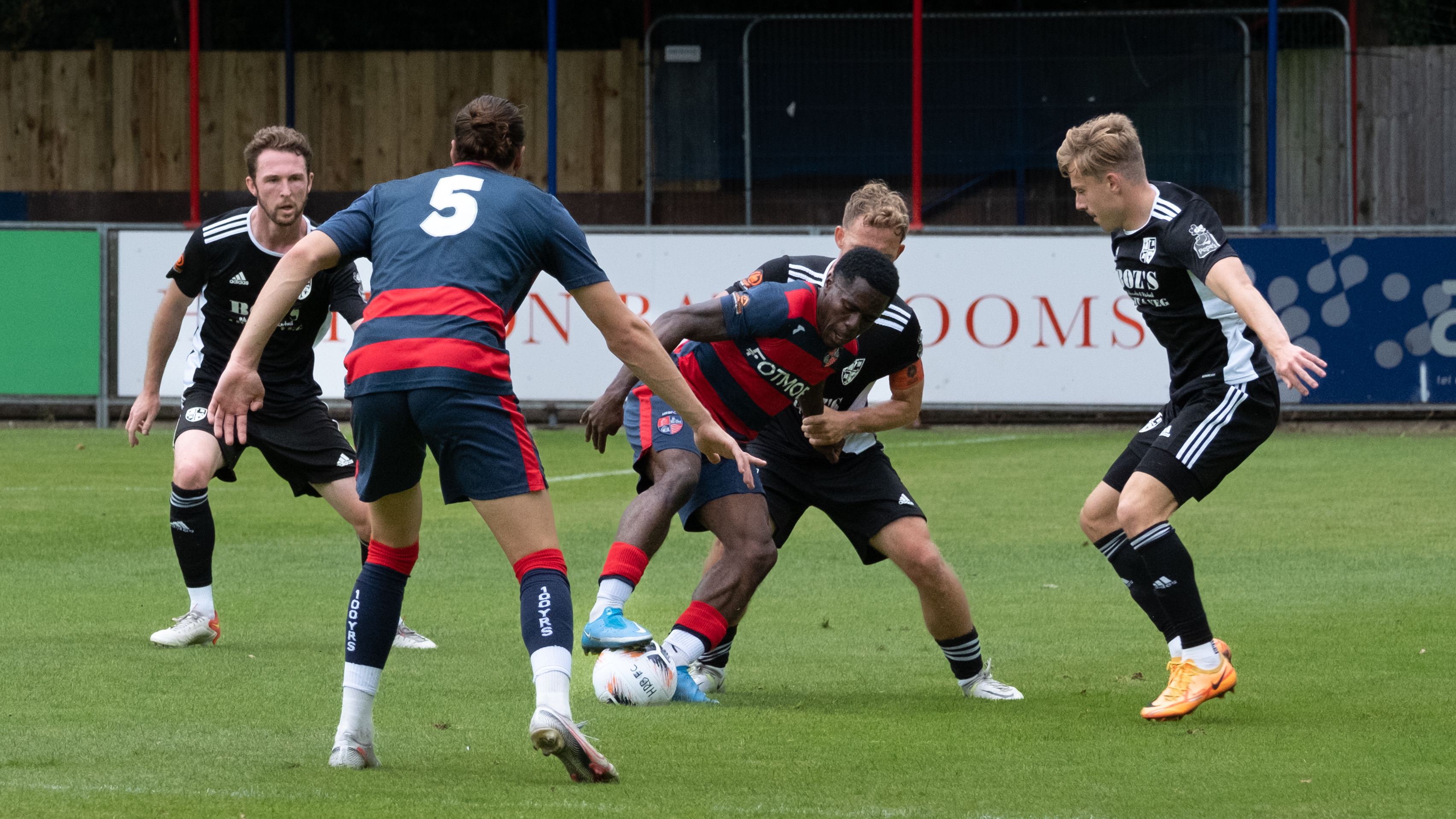 A footballer shielding the ball during a match