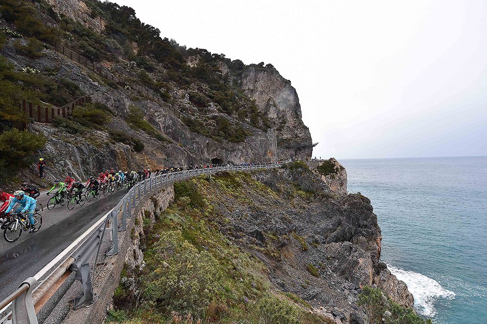 The peloton rides along the coast during Milan-San Remo.