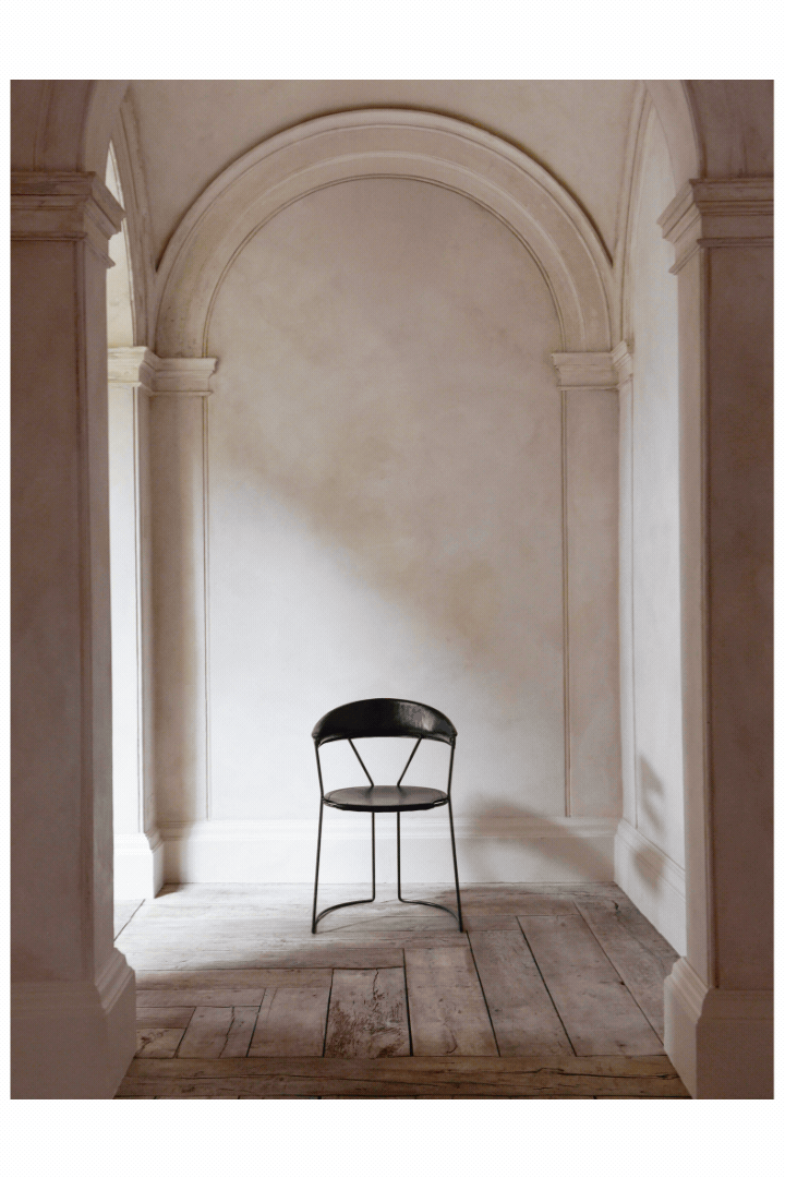 A rotating gif spotlighting three different artisanal chairs with a sculptural silhouette in a storied hallway of a palazzo with arched walls and stuccoed architecture.